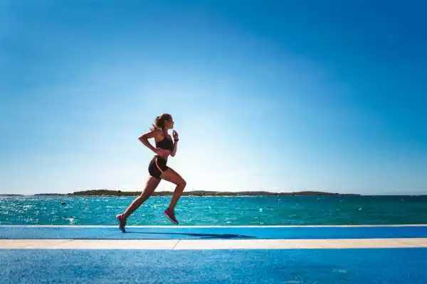 Woman running showing strong leg muscle Peterborough